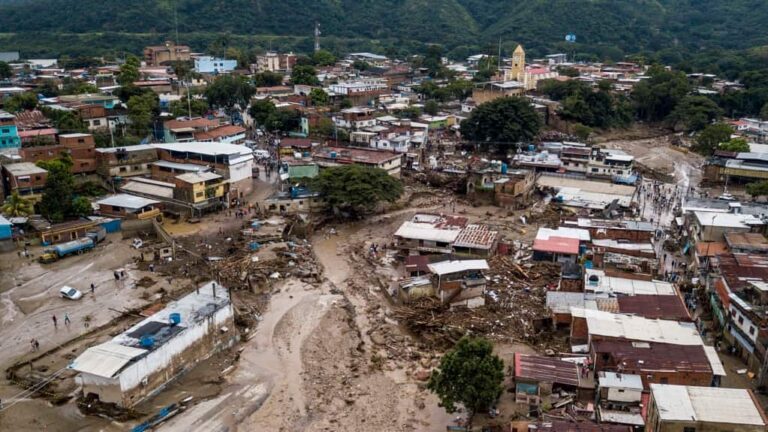 Calles inundadas luego de fuertes lluvias que provocaron el desbordamiento de un río en Las Tejerías, Venezuela, el domingo 9 de octubre de 2022. (Foto AP/Matias Delacroix)