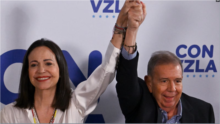 La líder de la oposición venezolana María Corina Machado levanta su mano junto a la del candidato presidencial Edmundo González Urrutia, en Caracas, el 29 de julio de 2024.