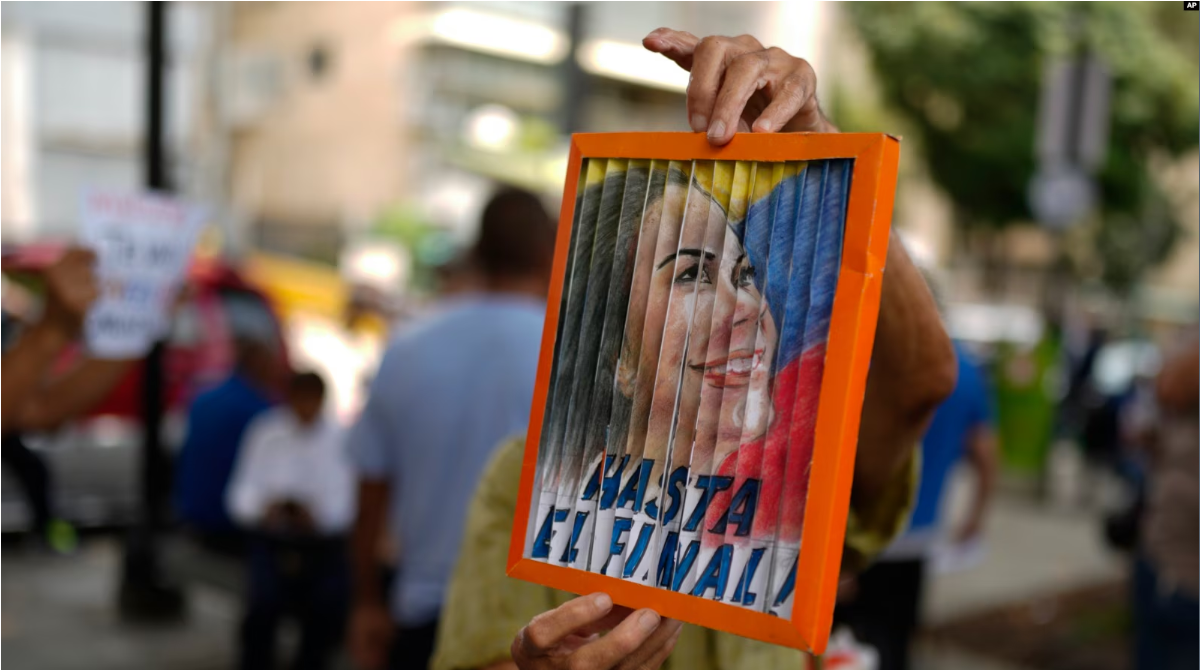 Un hombre sostiene una imagen de la líder opositora María Corina Machado durante una protesta contra la reelección del presidente Nicolás Maduro dos meses después de las disputadas elecciones en Caracas, el sábado 28 de septiembre de 2024.