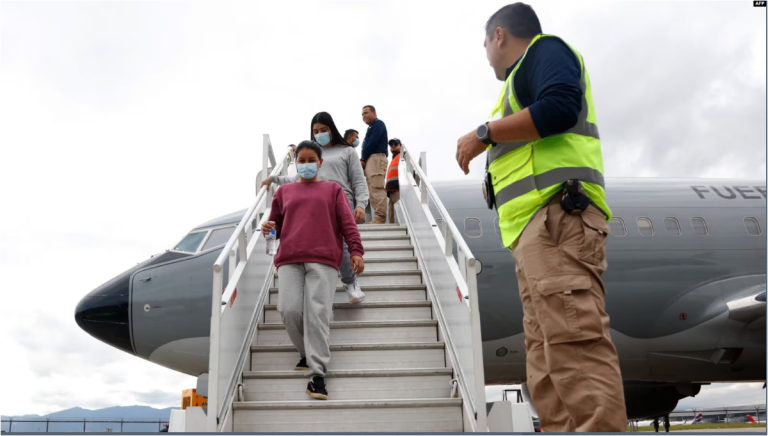 ARCHIVO - Esta imagen difundida por la Cancillería de Colombia, muestra a un oficial de inmigración junto a migrantes que descienden de un avión de la Fuerza Aérea Colombiana luego de ser deportados de EEUU, en Bogotá el 28 de enero de 2025.